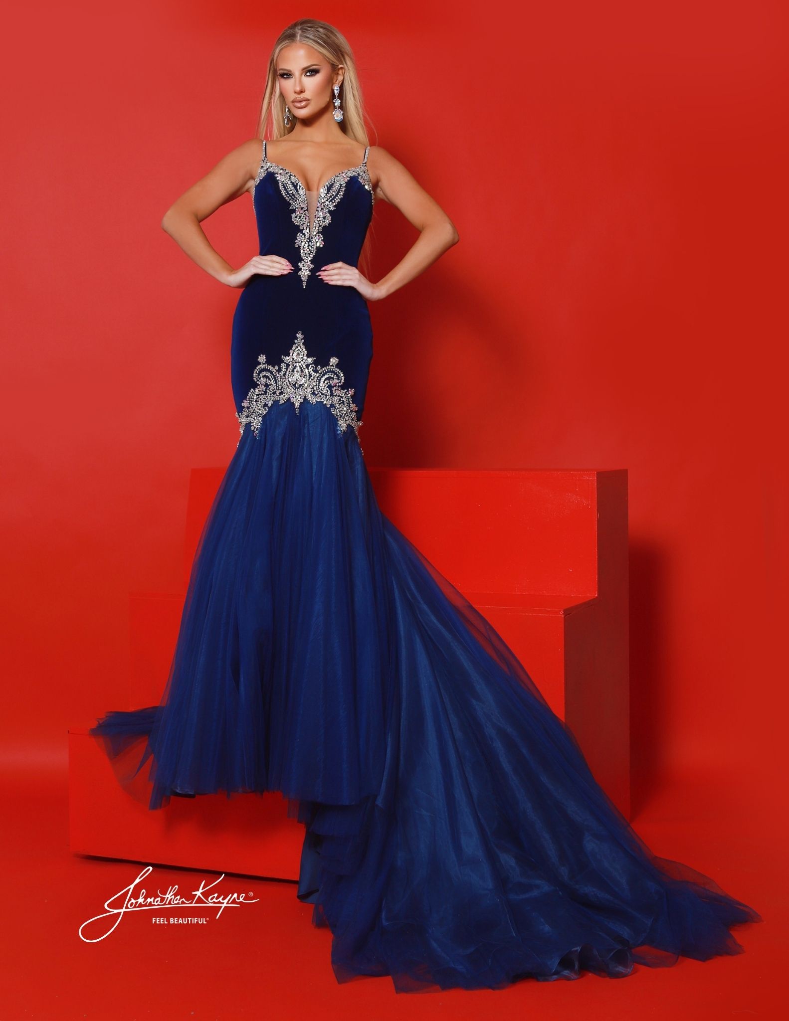 Royal blue mermaid gown with silver crystal embroidery. Strike velvet evening gown with flared tulle train and beaded illusion neckline, ideal for pageants and formal red carpet events.